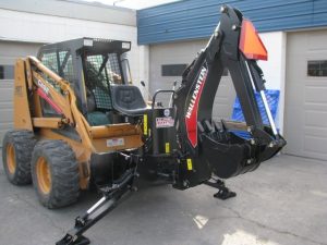 Skid steer back hoe with outriggers on a Case Skid Steer