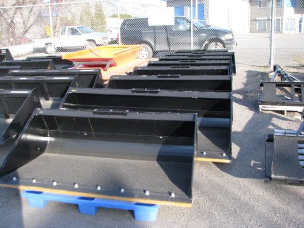 row of skid steer buckets on pallets row of skid steer buckets on pallets