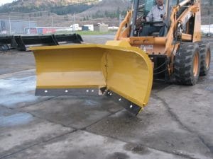 HLA V-blade snow blade mounted on a Case Skid Steer