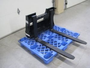 Pallet Forks with mini universal skid steer mount on pallet