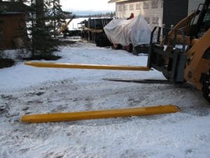 pallet fork extension mounted on skid steer pallet forks