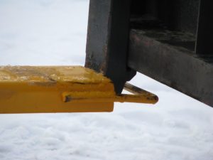 pallet fork extension mounted on skid steer pallet forks