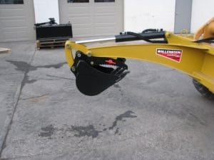 Skid Digger back hoe for skid steer showing mechanical thumb and bucket