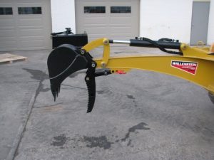 Skid Digger back hoe for skid steer showing mechanical thumb and bucket