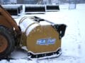 snow pusher attached to skid steer pushing snow