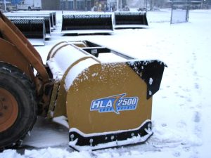 snow pusher attached to skid steer pushing snow