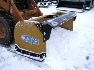 snow pusher attached to skid steer pushing snow