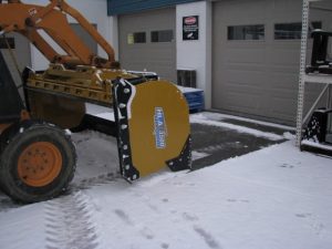 HLA snow pusher mounted on skid steer using back drag feature
