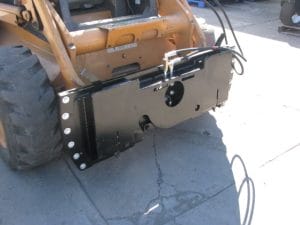 Tilt plate mounted on skid steer