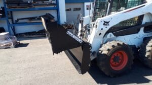 Skid Steer 4 in 1 Bucket in open position mounted on Bobcat