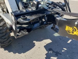 Skid Steer backhoe attachment mounted on bobcat