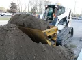 side discharge skid steer bucket
