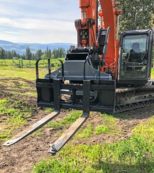 Hitachi Excavator with Excavator to Skid Steer adapter and set of skid steer pallet forks
