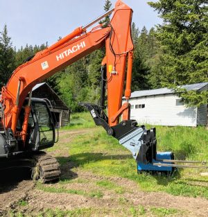 Hitachi Excavator with Excavator to Skid Steer adapter and set of skid steer pallet forks