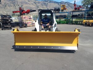 HLA snow wing 9-14 ft attached to Bobcat skid steer