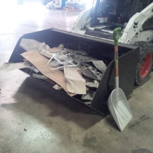 skid steer with scrap bucket full of construction waste